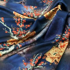 the fabric is blue with orange flowers and leaves on it's sides, along with dark blue background