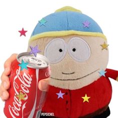 a person holding a coca cola can in front of a stuffed animal with stars on it