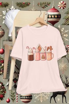 Get cozy this holiday season with this adorable hot cocoa-themed t-shirt featuring festive mugs adorned with candy canes, whipped cream, and Add a dash of holiday magic to your outfit with this cute holiday mug t-shirt! Featuring a lineup of festive hot cocoa mugs with candy canes and gingerbread details, this tee is perfect for winter outings, cozy evenings, or as a thoughtful Christmas gift. It's a must-have for hot cocoa lovers and anyone who enjoys spreading holiday cheer. Don't wait—get you Hot Cocoa Mugs, Perfect Winter Outfit, House Family, Holiday Mug, Gingerbread Christmas