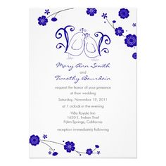 an elegant wedding card with blue flowers and swirls on the front, in white