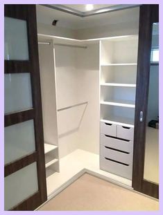 an empty walk in closet with shelves and drawers