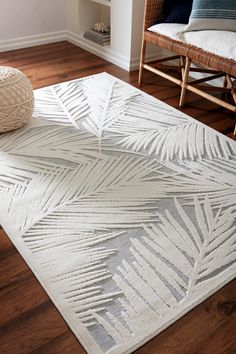 a white rug with palm leaves on it