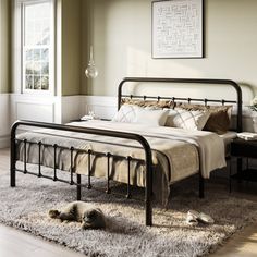 a bed sitting on top of a wooden floor next to a window