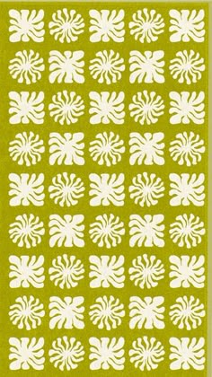 a green rug with white flowers on the front and back of it, in an abstract pattern