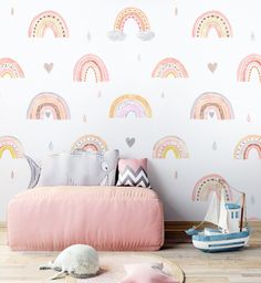 a child's room with rainbow wallpaper and pastel pink sofa in the foreground