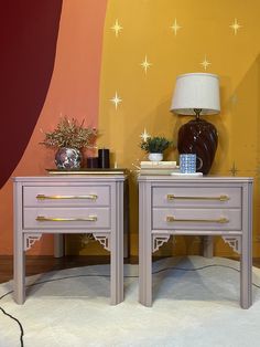 two grey nightstands sitting next to each other on top of a rug