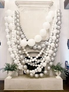 a bunch of balloons that are on top of a table in front of a fireplace