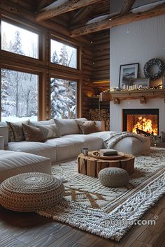 a living room filled with furniture and a fire place in front of a large window