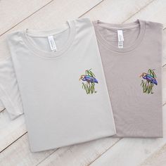 Discover the Elegance and Comfort of Our Embroidered Blue Heron T-Shirt! Elevate your style with our handcrafted, unisex t-shirts, showcasing a gracefully embroidered blue heron. Ideal for any season, these tees merge fashion with function, making them a quintessential pick for daily wear. Each piece is constructed from premium materials, ensuring enduring quality and a gentle feel. Discover More Options: Love this design? We offer it in additional apparel options that might catch your eye:  Swe Basic Relaxed Fit Top With Custom Embroidery, Basic Cotton Tops With Custom Embroidery And Relaxed Fit, Casual Relaxed Fit T-shirt With Machine Embroidery, Relaxed Fit Cotton Top With Machine Embroidery, Cotton Tops With Machine Embroidery And Relaxed Fit, Cotton T-shirt With Machine Embroidery, Relaxed Fit, Short Sleeve Cotton Top With Machine Embroidery, Cotton Top With Machine Embroidery, Short Sleeve, Summer Crew Neck Top With Machine Embroidery