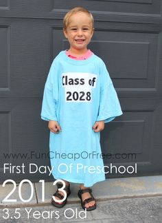 a young boy standing in front of a garage door wearing a class of 208 shirt