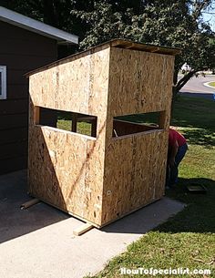 a man standing next to a wooden structure on the side of a house under construction