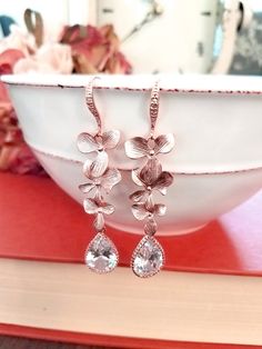 #dropearrings #dangleearrings #weddingearrings #bridalearrings #bridesmaidjewelry #bridesmaidgift #christmasearrings #lalacrystal #rosegoldjewelry #rosegoldearrings #orchidearrings #rosegoldorchid #holidaygift #gift for her Elegant Rose Gold Earrings For Wedding, Elegant Rose Gold Teardrop Earrings For Anniversary, Elegant Rose Gold Teardrop Earrings For Wedding, Rose Gold Bridal Earrings With Elegant Design For Party, Formal Rose Gold Earrings With Rose Design, Formal Rose Gold Flower Earrings, Rose Gold Earrings With Elegant Design For Party, Rose Gold Elegant Earrings For Party, Elegant Rose Gold Earrings For Party