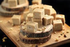 pieces of food sitting on top of a wooden cutting board