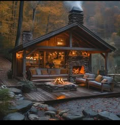 a cabin in the woods is lit up with candles and lights on it's porch