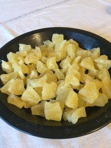 a black bowl filled with cut up food on top of a white tablecloth covered table