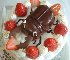 there is a cake decorated with strawberries and chocolate