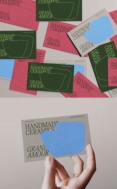 hand holding up two different colored envelopes