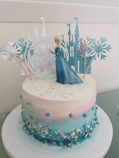 there is a cake with frosting and decorations on it that looks like a frozen princess