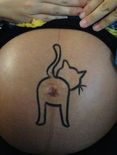 a pregnant woman with a cat tattoo on her belly