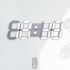 an electronic clock is displayed on the wall