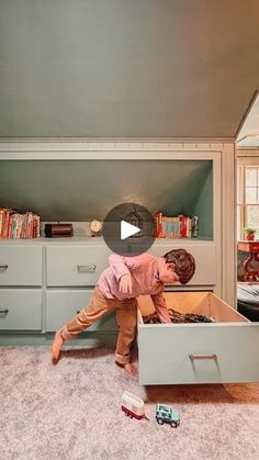 a man is trying to open a drawer in the living room with his feet on the floor