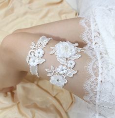 "This floral lace garter is made of organza petals, satin petals and crystals on delicate embroidered lace, match the stretchy organdy band. * organza and satin petals * crystals, faux pearls * Lace applique size : 6.5\" , 3\" long * stretch band available in white,ivory and blue * comes with a box CUSTOM ORDER Please choose your thigh size (where you will be wearing the garter) and leave your wedding date(for a timely delivery) in the \"note to seller\" box during your checkout. SHIPMENT ** Our Garter Set Wedding, Wedding Garter Blue, Lace Garter Set, Garter Wedding, Blue Garter, Bridal Garters Set, Wedding Garter Set, Lace Garter, Pearl And Lace