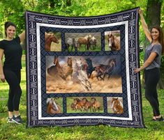 two women standing next to a large quilt with horses on it and one holding up the blanket