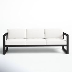 a black and white couch sitting on top of a white floor