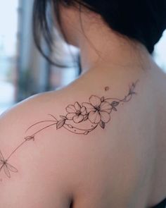 a woman with a flower tattoo on her shoulder