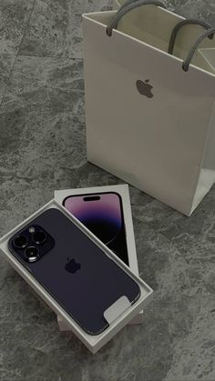 an iphone 11 is in its box and it's next to the bag