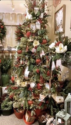 a christmas tree decorated with ornaments and greenery