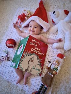 a baby is laying on the floor with a book