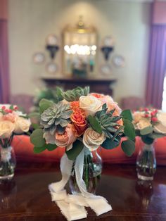 there are many vases with flowers in them on the table