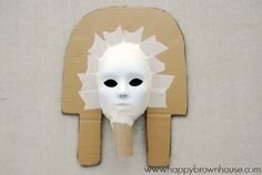 a cardboard mask is attached to the wall