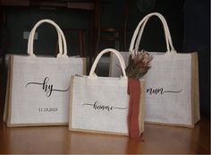 three bags with names on them sitting on a table