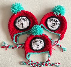 two crocheted hats with cat in the hat faces