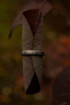 I love the design of this ring, I call it my feathery fern ring because that's what it looks like to me. The textured wraps around the entire band, and the inside of the band is rounded making it incredibly comfortable to wear. See last picture. This is a good size handcrafted sterling silver band (3.5 mm wide) with a nice weight to it. It looks great alone, or paired with other stacking rings. I've been wearing mine stacked with my triple moon ring nonstop for the last few months and it's the m Adjustable Hand Forged Engraved Ring, Bohemian Stackable Adjustable Rings For Anniversary, Bohemian Adjustable Stackable Rings For Anniversary, Bohemian Style Engraved Ring As Gift, Bohemian Engraved Open Ring For Promises, Bohemian Engraved Promise Ring, Bohemian Etched Engraved Ring As Gift, Nature-inspired Adjustable Stackable Rings For Promise, Fern Ring