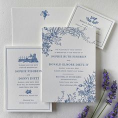 the wedding stationery is laid out on top of each other, with purple flowers