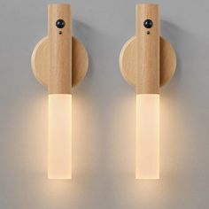 two wooden lights are on the wall next to each other