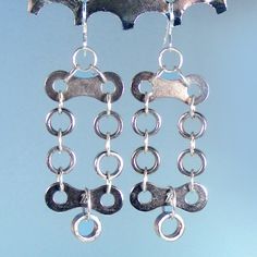 The elements in these statement earrings are part pf a bicycle chain. Two inches long, they catch the light and sway gently as you move. They are made from a new silver bike chain I painstakingly took apart. After cleaning the bike bits the fun of designing begins. The length of these earrings is dramatic but not over the top. It's interesting using a material considered industrial (bike chain) as the basis for lovely jewelry. A wonderful gift for a bike enthusiast or anyone who likes unique thi Bike Craft, Bike Rollers, Chain Drop Earrings, Diy Bracelets Tutorials, Bicycle Chain, Bike Chain, Unusual Jewelry, Beaded Bracelet Patterns, Chain Links