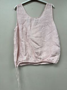 Introducing our luxurious Two Pocket Drawstring Italian Linen Tank Top. Made with the finest Italian linen, this one-size top features a round neck and drawstring detailing for a comfortable and elegant fit. Perfect for any occasion, this top is both fun and sophisticated. Casual Drawstring Tank Top For Beach, Summer Drawstring Tops For Loungewear, Drawstring Tank Top For Beach In Spring, White Cotton Top With Drawstring Tie, White Cotton Tops With Drawstring Tie, Summer Cotton Top With Drawstring Tie, Sleeveless Drawstring Tops For Loungewear, White Summer Tops With Drawstring, Summer Cotton Tank Top With Drawstring