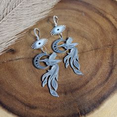 Delicate and unique etched hummingbird dangles in stainless steel with sun and moon phase charms and gorgeous.  These earrings have an approximate drop_length of 3.5 inches and are very lightweight!! The posts are PAVE silver-plated ear wires - hypoallergenic and sensitive-ears friendly.   💗 Shipping: *Free standard shipping does NOT include tracking on your parcel. If you would like it to be tracked, please choose a shipping upgrade at checkout. 💗 Packaging: I put a lot of care into my packag Unique Silver Jewelry With Bird Design, Silver Dangle Jewelry With Bird Design, Unique Sun And Moon Design Dangle Jewelry, Adjustable Silver Jewelry With Bird Design, Silver Bird Design Drop Earrings, Silver Drop Earrings With Bird Design, Silver Sun And Moon Drop Earrings, Silver Sun And Moon Design Drop Earrings, Metal Dangle Jewelry With Etched Details