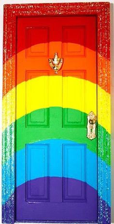 a rainbow door is painted with glitter