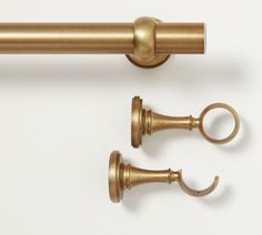 an image of brass curtain hardware on a white background with clippings for the handles