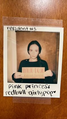 a woman holding a sign that says pink princess redbull girlpop