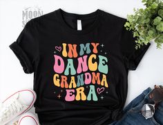 In My Dance Grandma Era T Shirt, Dance Grandma Gift, Trendy Era Tee, Swiftie Dance Crewneck, Groovy Quote Shirts  Moonshine Designs offers custom made t-shirts featuring unique designs for daily wear, special occasions, or gift giving.  By offering a multitude of color options, sizes and designs, we are able to provide customers a quality product, tailored to your specific needs and desires. Moonshine Designs was created as an extension of the Etsy shop SunflowerChicSVG. Please feel free to brow Groovy Quote, Grandma Era, Quote Shirts, Custom Made T Shirts, Grandma Gift, How To Make Tshirts, Unisex Shirts, Grandma Gifts, Shirts With Sayings