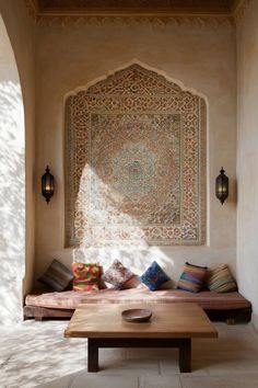 a room with a couch, table and rug on the wall