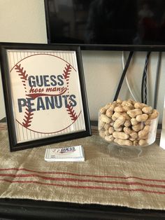 there is a sign that says guess how many peanuts are in front of the tv