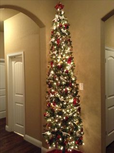 a decorated christmas tree in the corner of a room