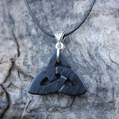 "This unique and intricate hand-carved Irish Bog Oak Celtic pendant will be made for you, or a loved one, in my studio on the West of Ireland. Bog Oak comes from ancient forests that once covered Ireland. Huge oaks have been buried in peat bogs and preserved from decay by the acidic and anaerobic bog conditions, sometimes for hundreds or even thousands of years. The wood is usually stained black by tannin dissolved in the acidic water. Bog-wood represents the early stages in the fossilization of Symbolic Black Etched Jewelry, Artisan Black Carved Jewelry, Artisan Carved Black Necklace, Artisan Black Carved Necklace, Artisan Black Engraved Necklace, Black Carved Symbolic Necklace, Black Symbolic Carved Necklace, Symbolic Black Carved Necklace, Black Etched Spiritual Jewelry